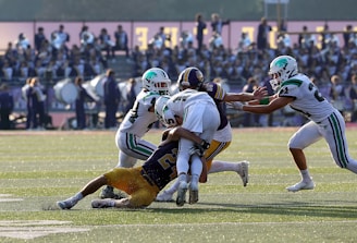 a group of football players playing a game of football