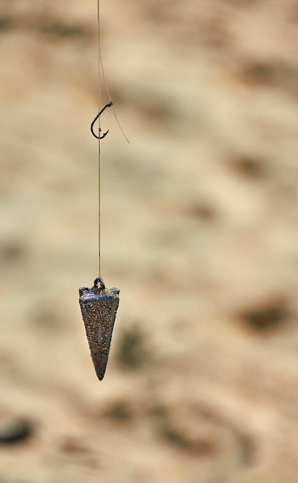 a wind chime hanging from a wire in the air
