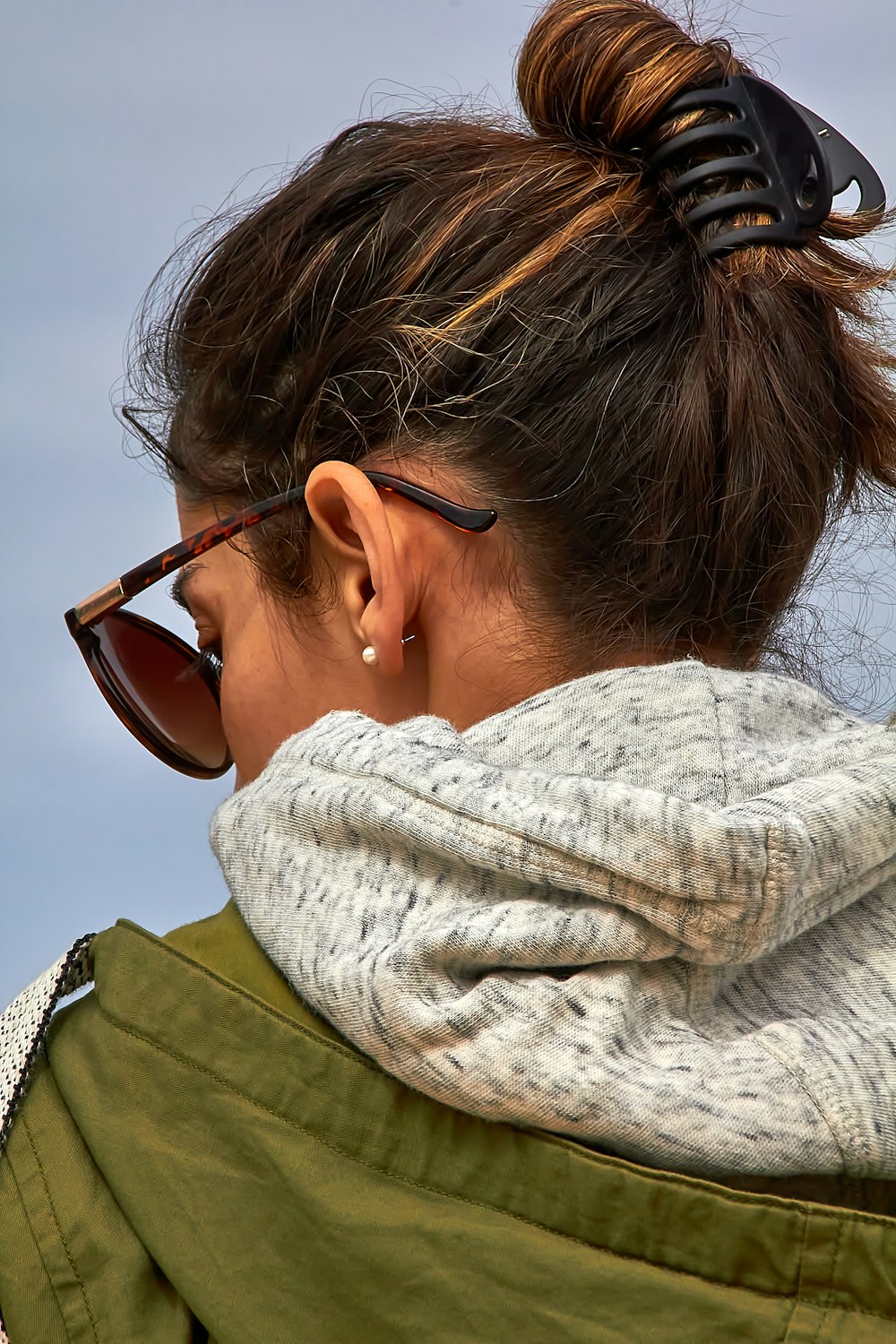 a woman wearing sunglasses and a scarf around her neck