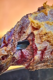 a piece of meat with a knife sticking out of it