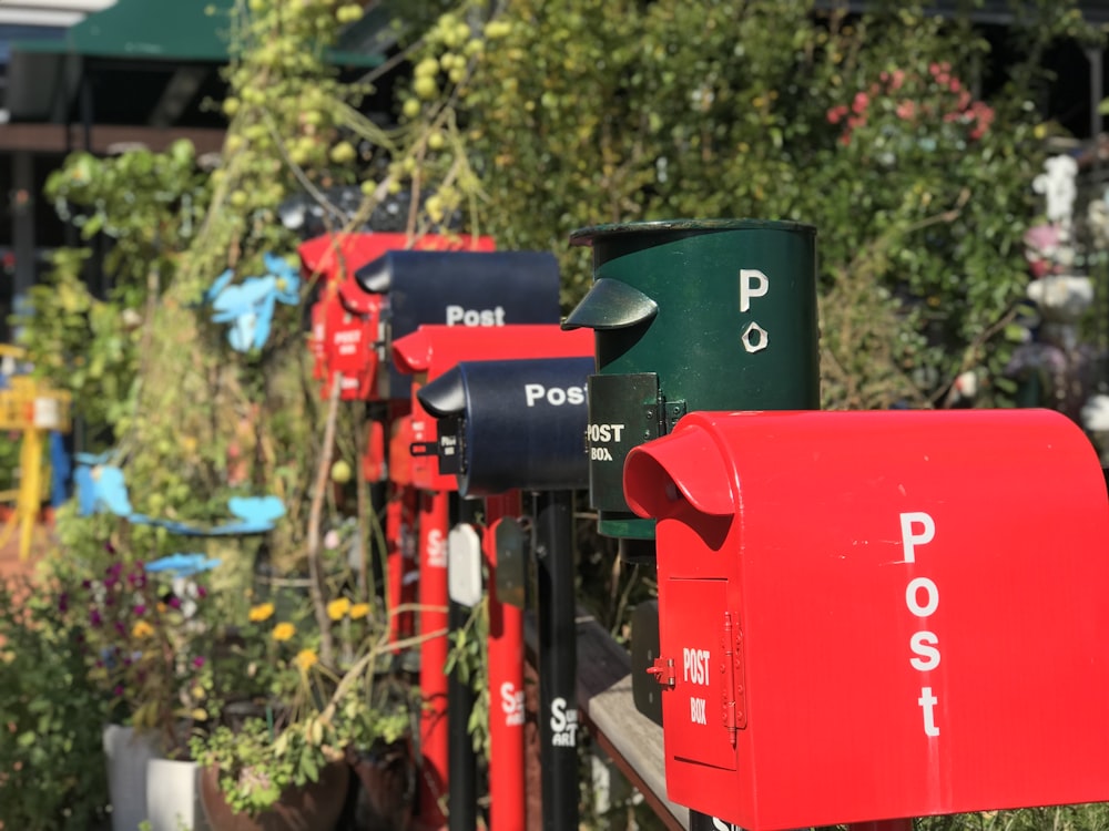 a row of red and blue mail boxes sitting next to each other