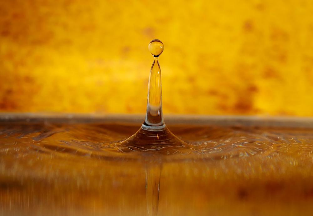 a drop of water that is falling into the water