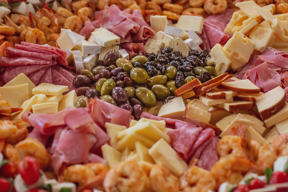 a variety of cheeses, meats, and other foods