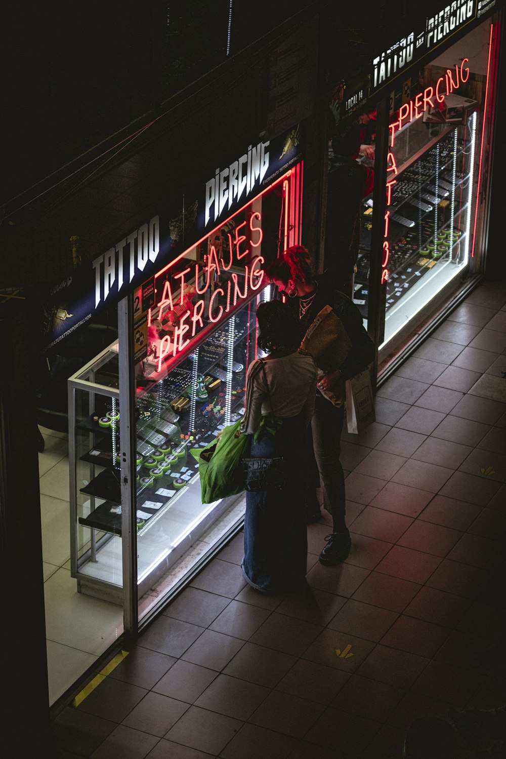 a couple of people standing outside of a store