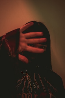 a woman covering her face with her hands