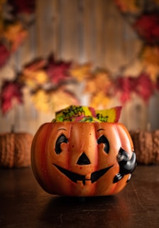 a carved pumpkin sitting on top of a wooden table