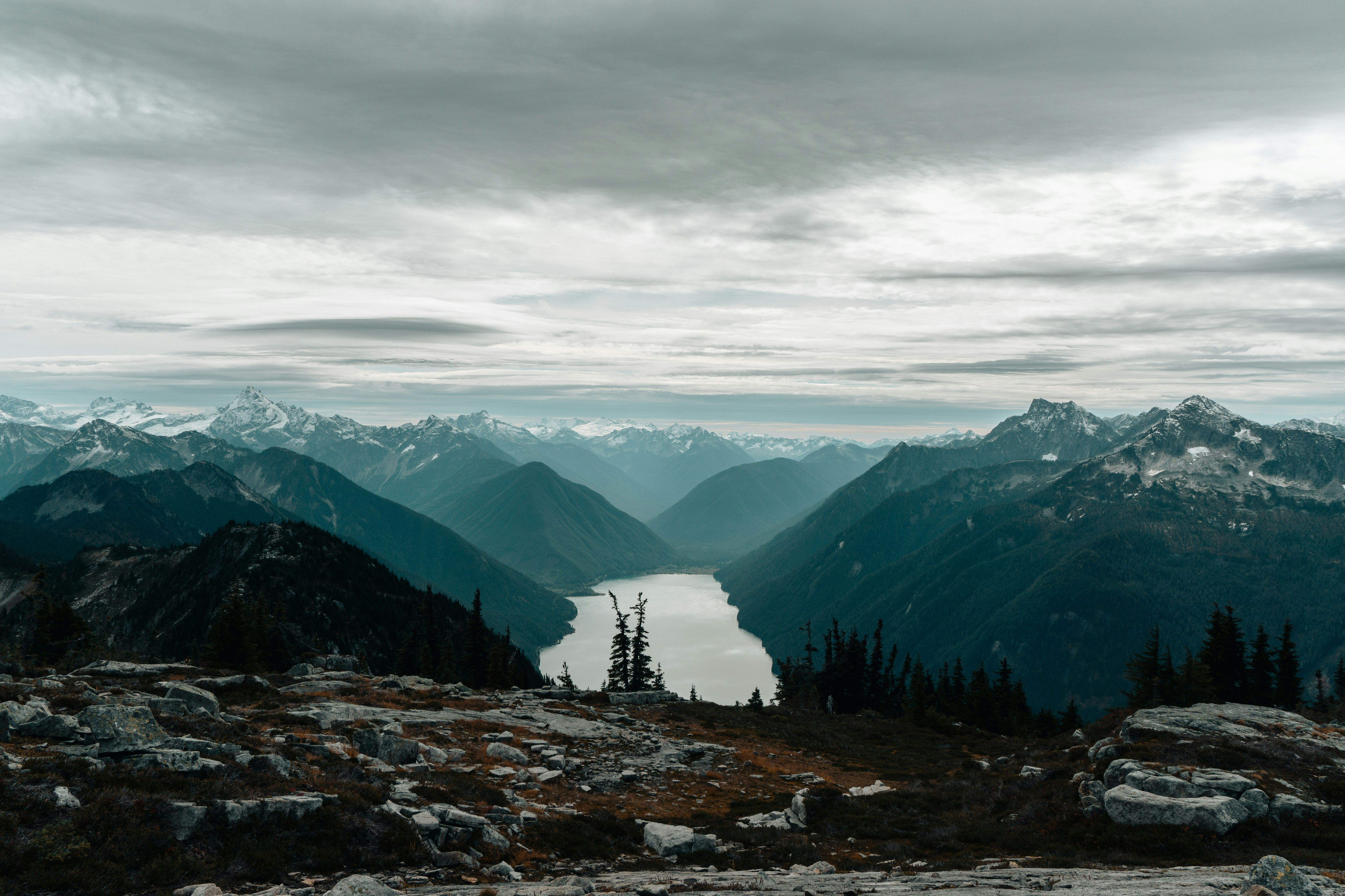 a view of a lake and mountains from the top of a mountain