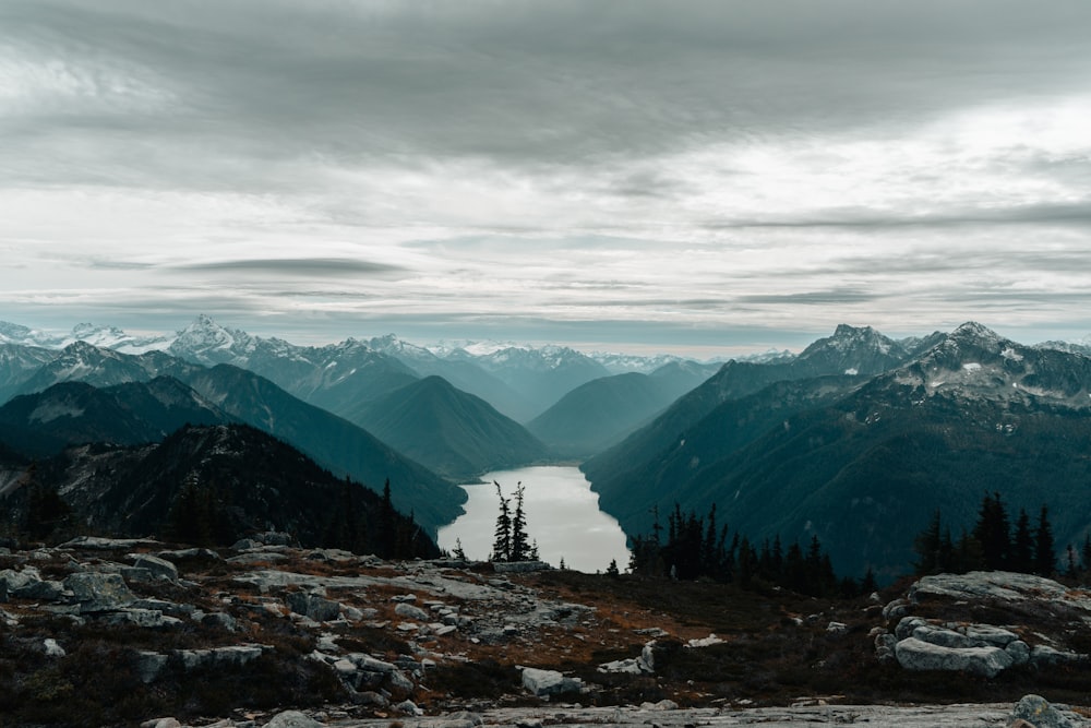 a view of a lake and mountains from the top of a mountain