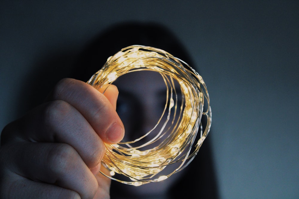 a person holding a string of lights in their hand