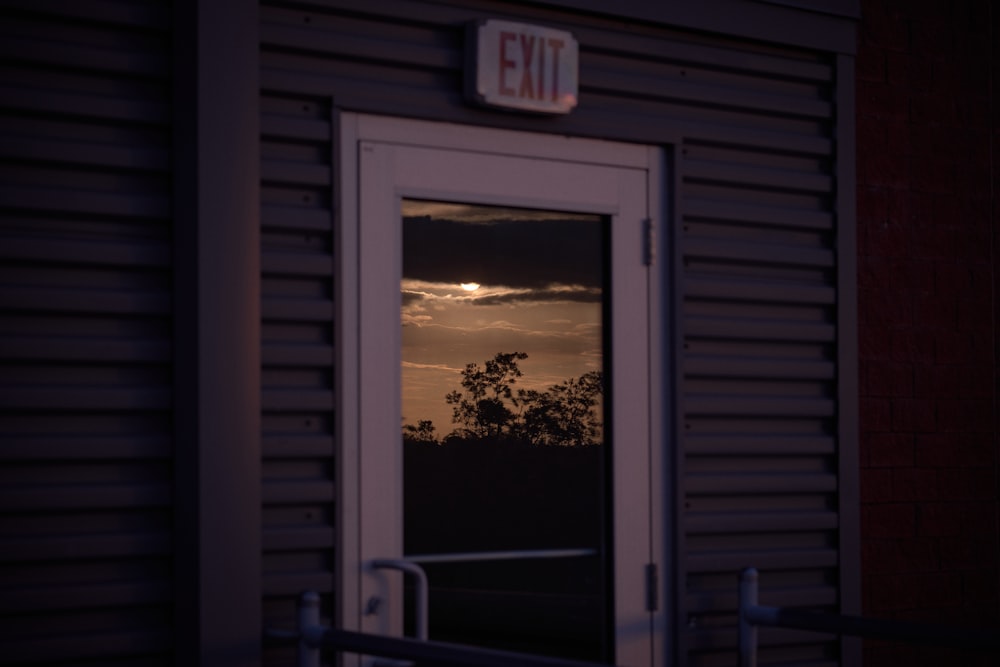 a sunset seen through a door of a building