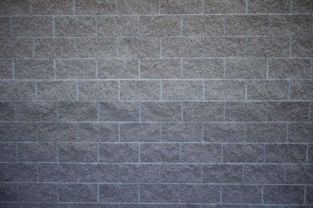 a gray brick wall with a white background