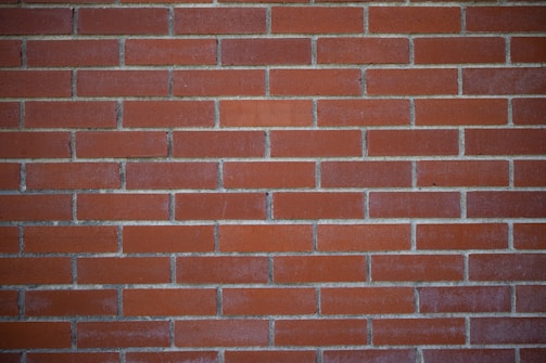 a close up of a red brick wall