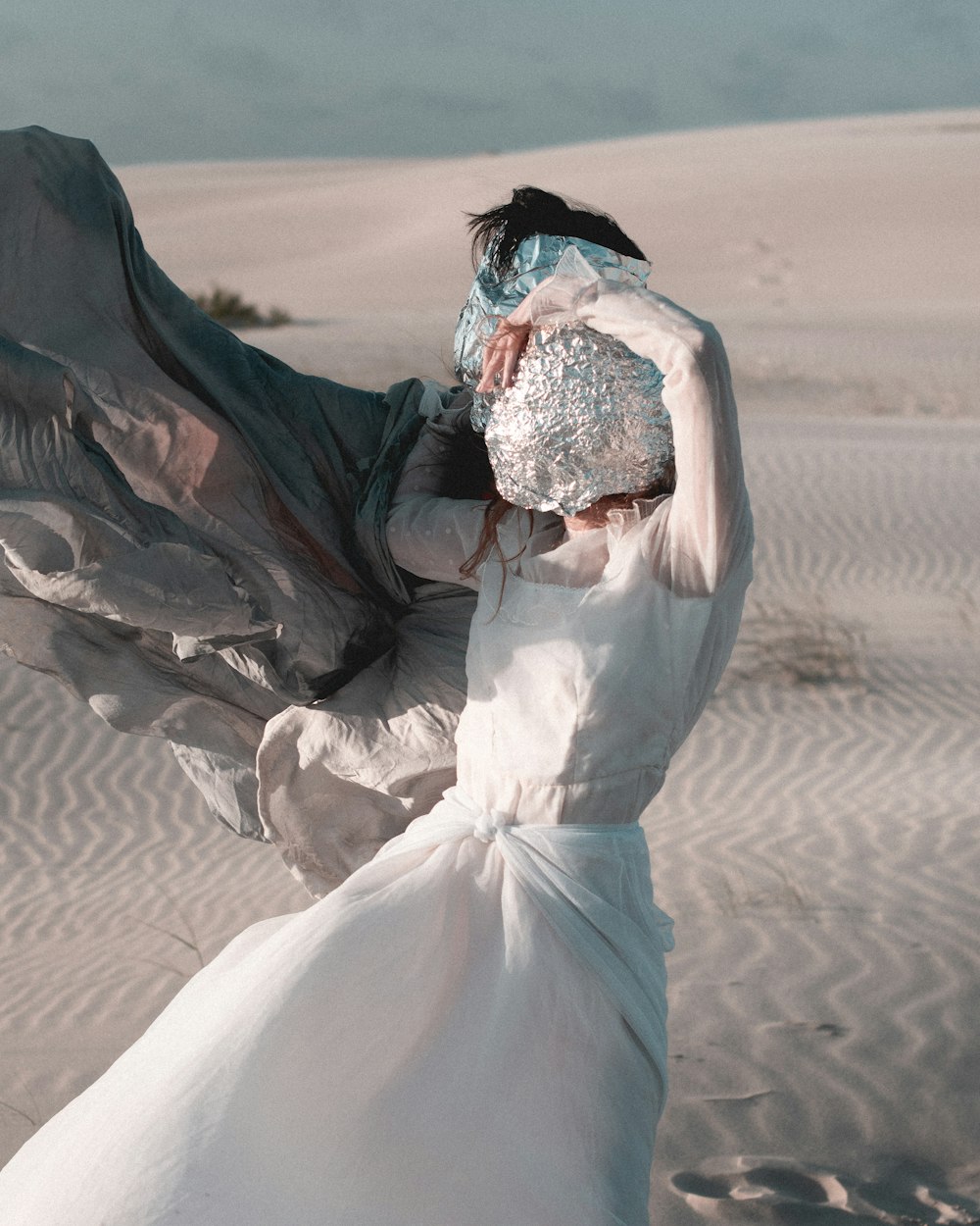 a woman in a white dress with a veil on her head