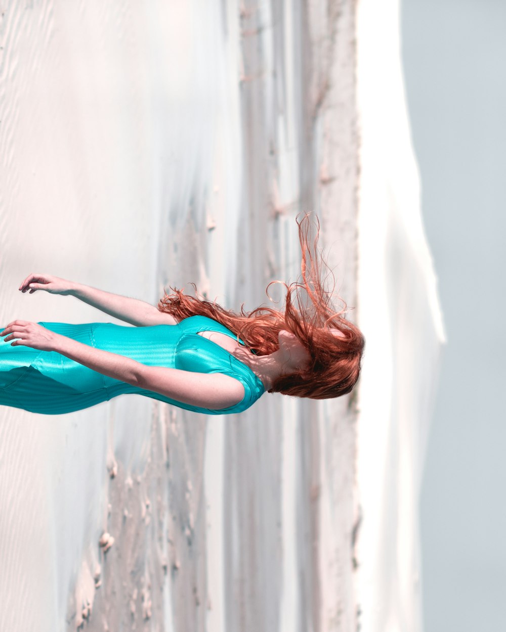 a woman in a blue dress is floating in the air