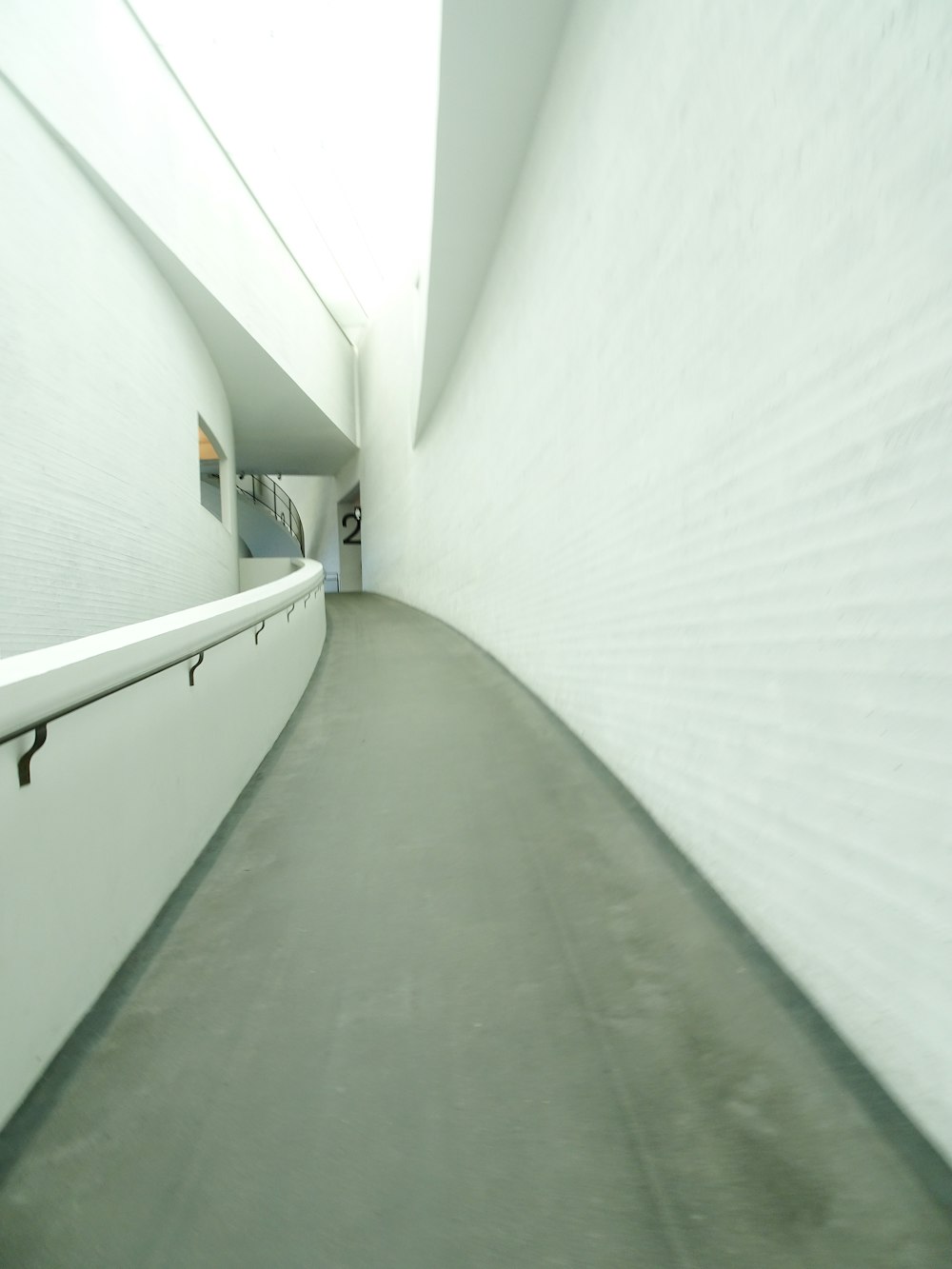 a white building with a long white wall