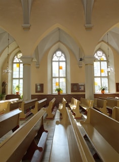 a church filled with wooden pews and windows
