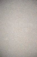 Close-up of skilled hands applying smooth microcement finish on a modern wall.