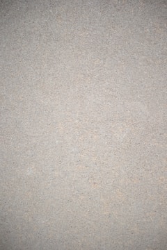 Close-up of a smooth cement finish wall with subtle texture in a modern living room.