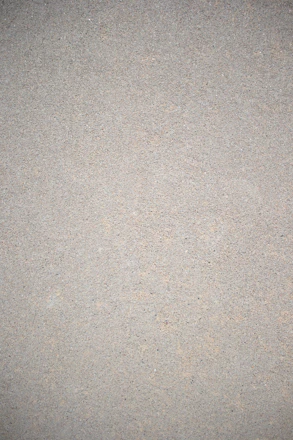 Close-up of a smooth, freshly applied microcement surface with natural light highlighting texture.