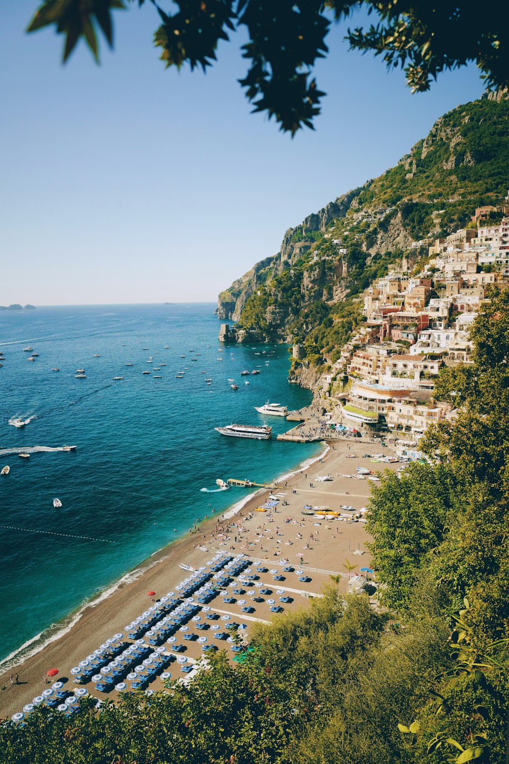 a beach with a bunch of boats in the water