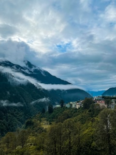 a scenic view of a town nestled in the mountains