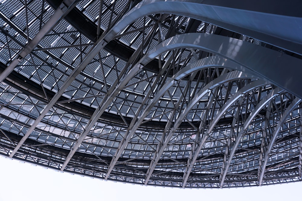 a large metal structure with a sky in the background