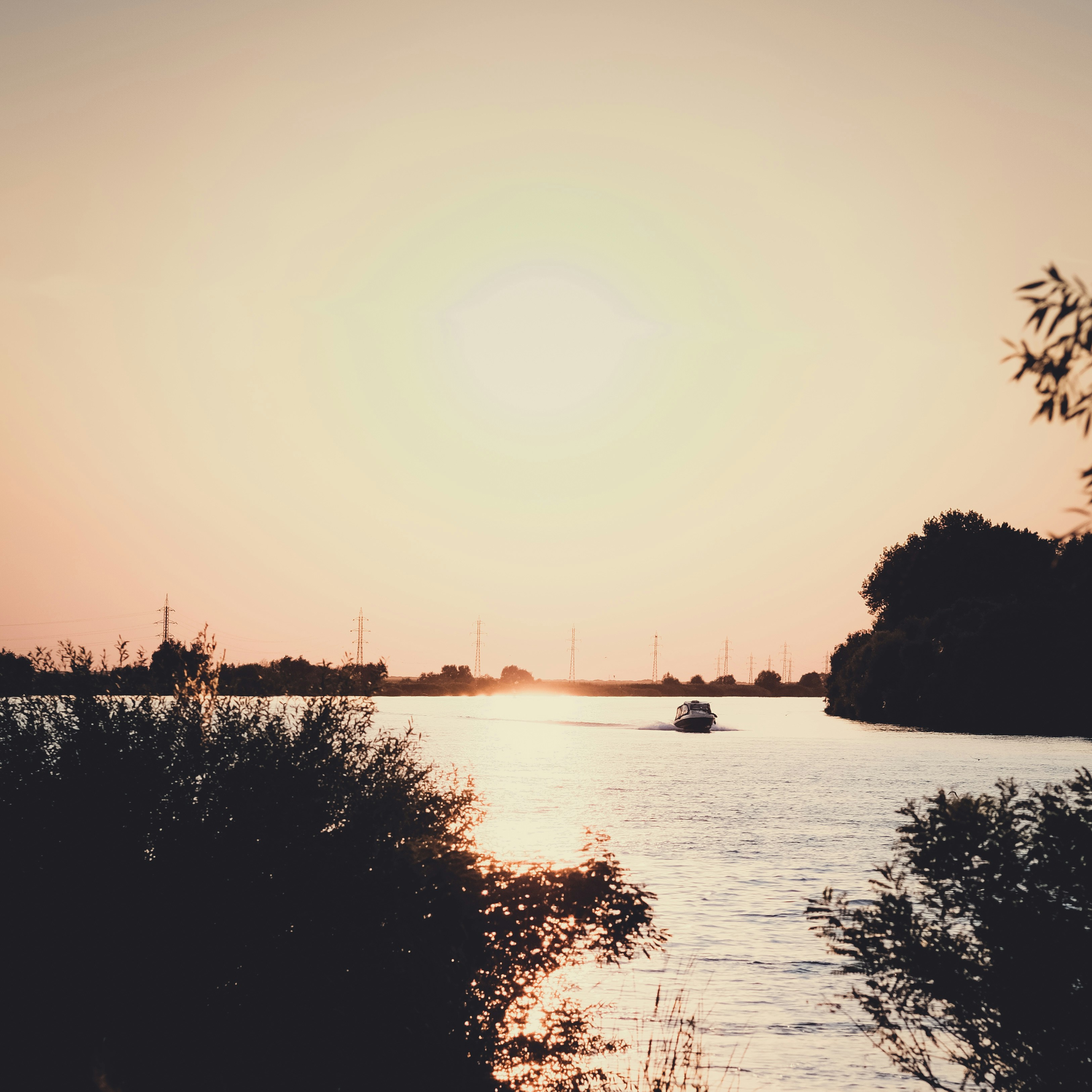 the sun is setting over a body of water