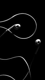 A minimalist audio headset displayed elegantly against a white background, highlighting its sleek lines and craftsmanship.