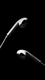 A pair of earbuds displayed in a minimalist 3D-style showcase with subtle glowing accents and smooth shadows.