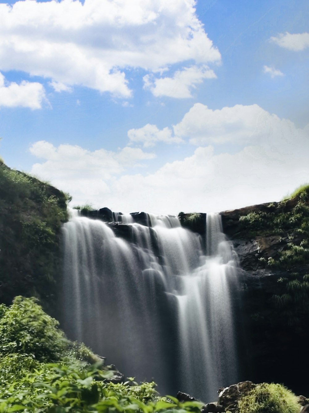 a very tall waterfall with lots of water