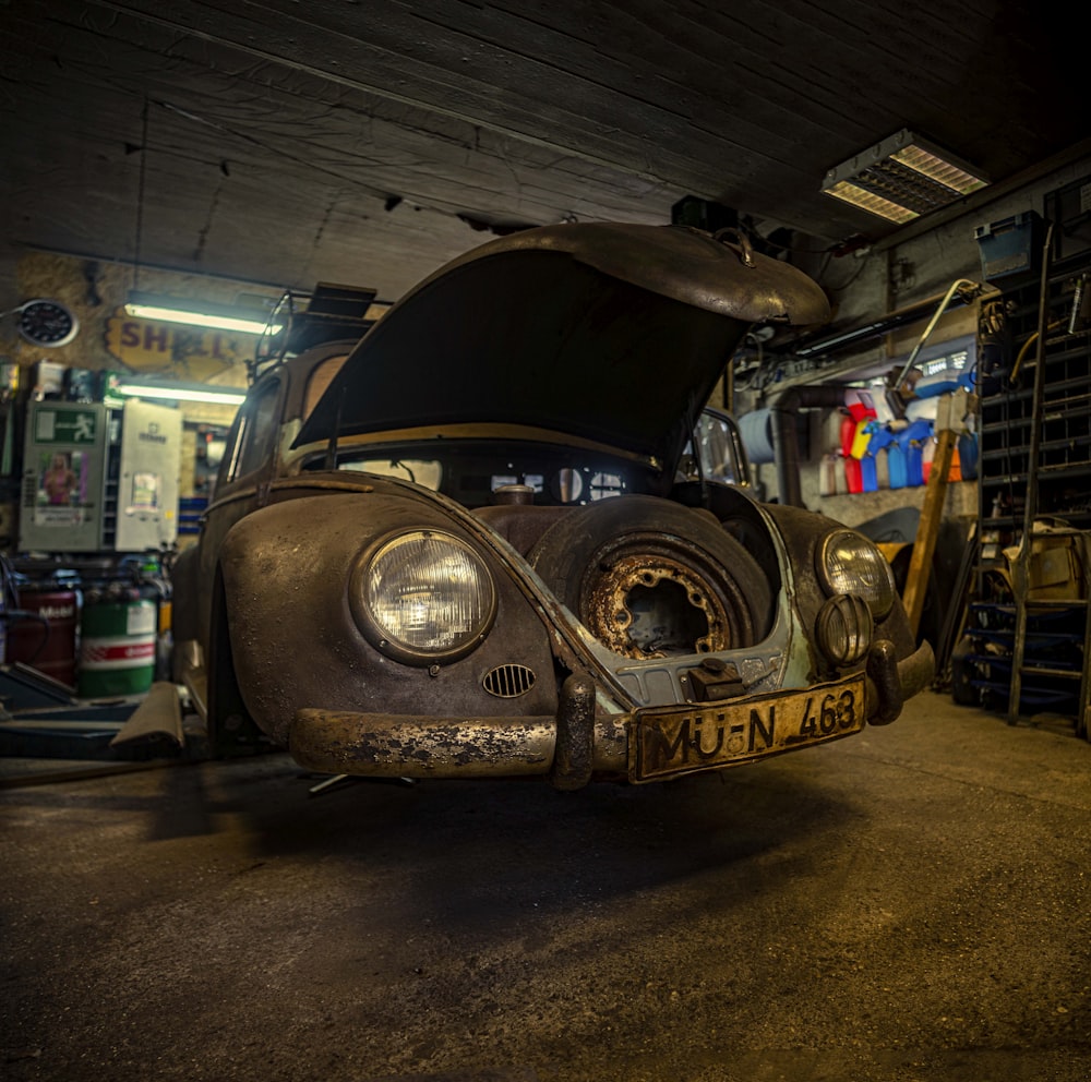 an old car is parked in a garage