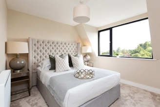 a bedroom with a large bed and a large window