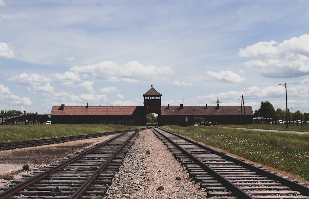 a train track with a building in the background