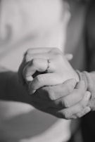 a close up of two people holding hands