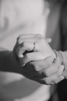 a close up of two people holding hands