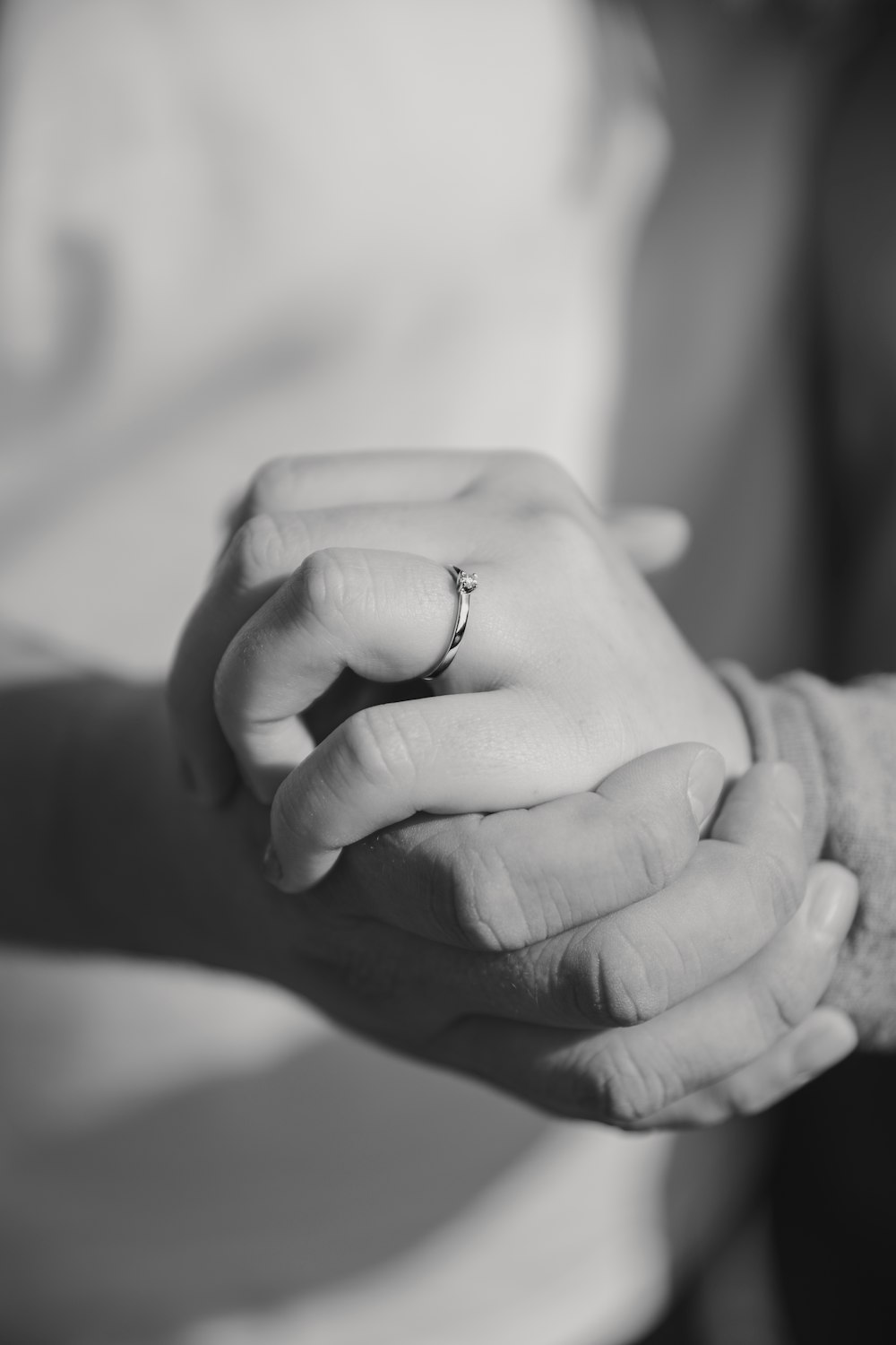 a close up of two people holding hands