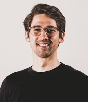 a man wearing glasses and a black shirt