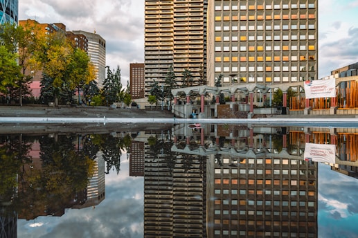 a very tall building sitting next to a body of water