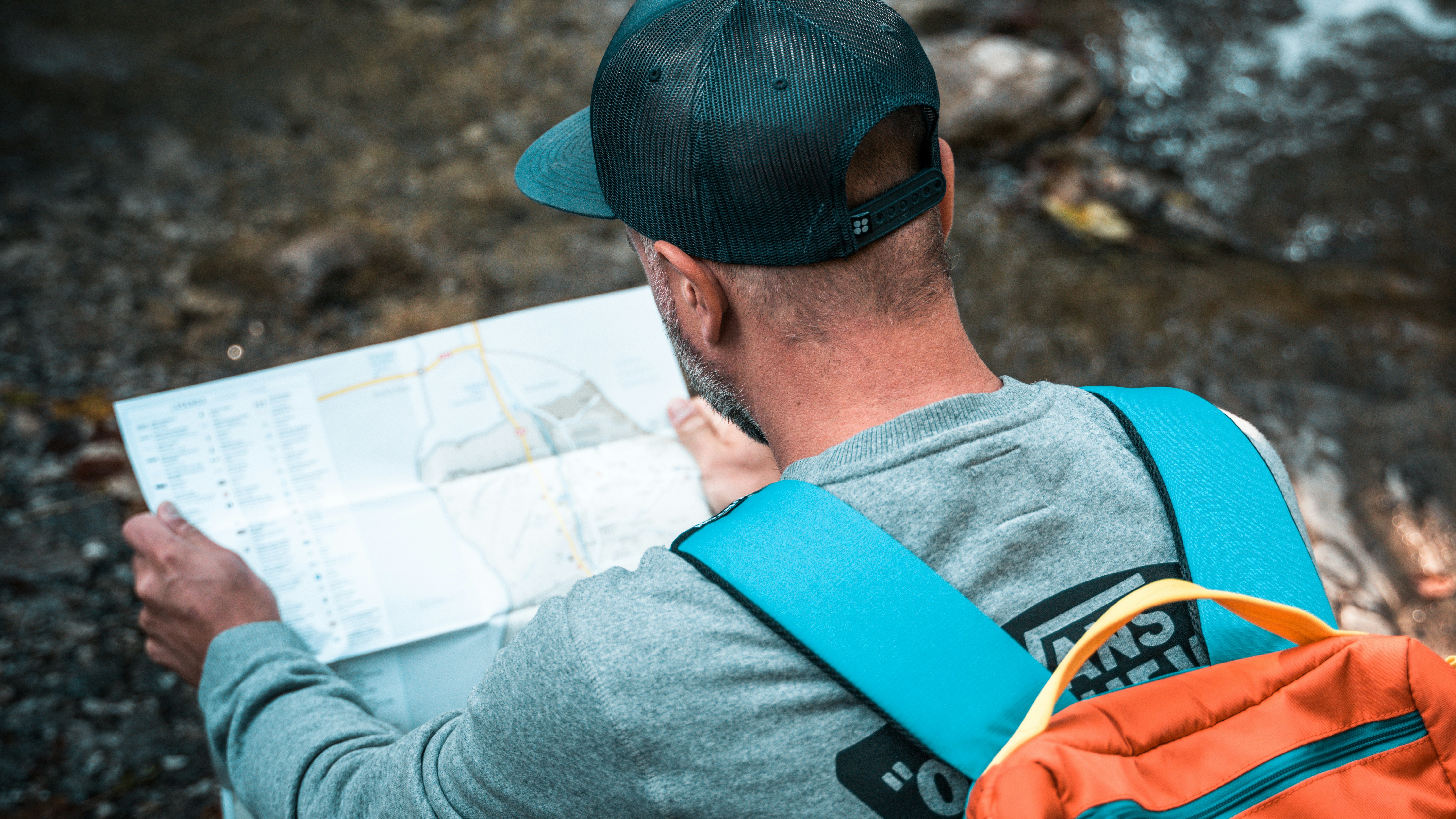 Hiker studying a map at a trailhead - Solo hiking trips