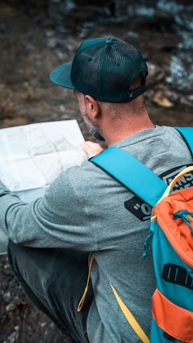 a man with a backpack looking at a map
