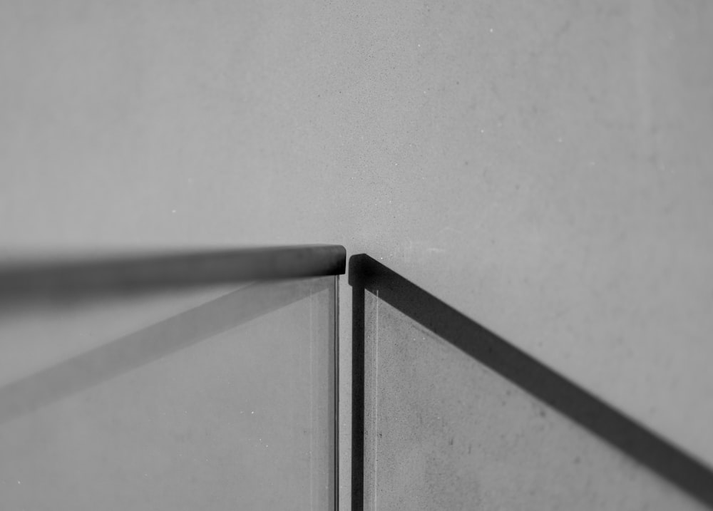 a black and white photo of a corner of a wall