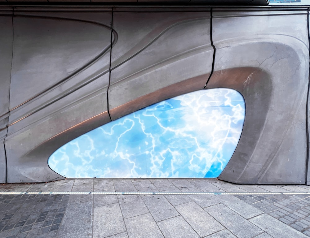 a reflection of a pool in the side of a building