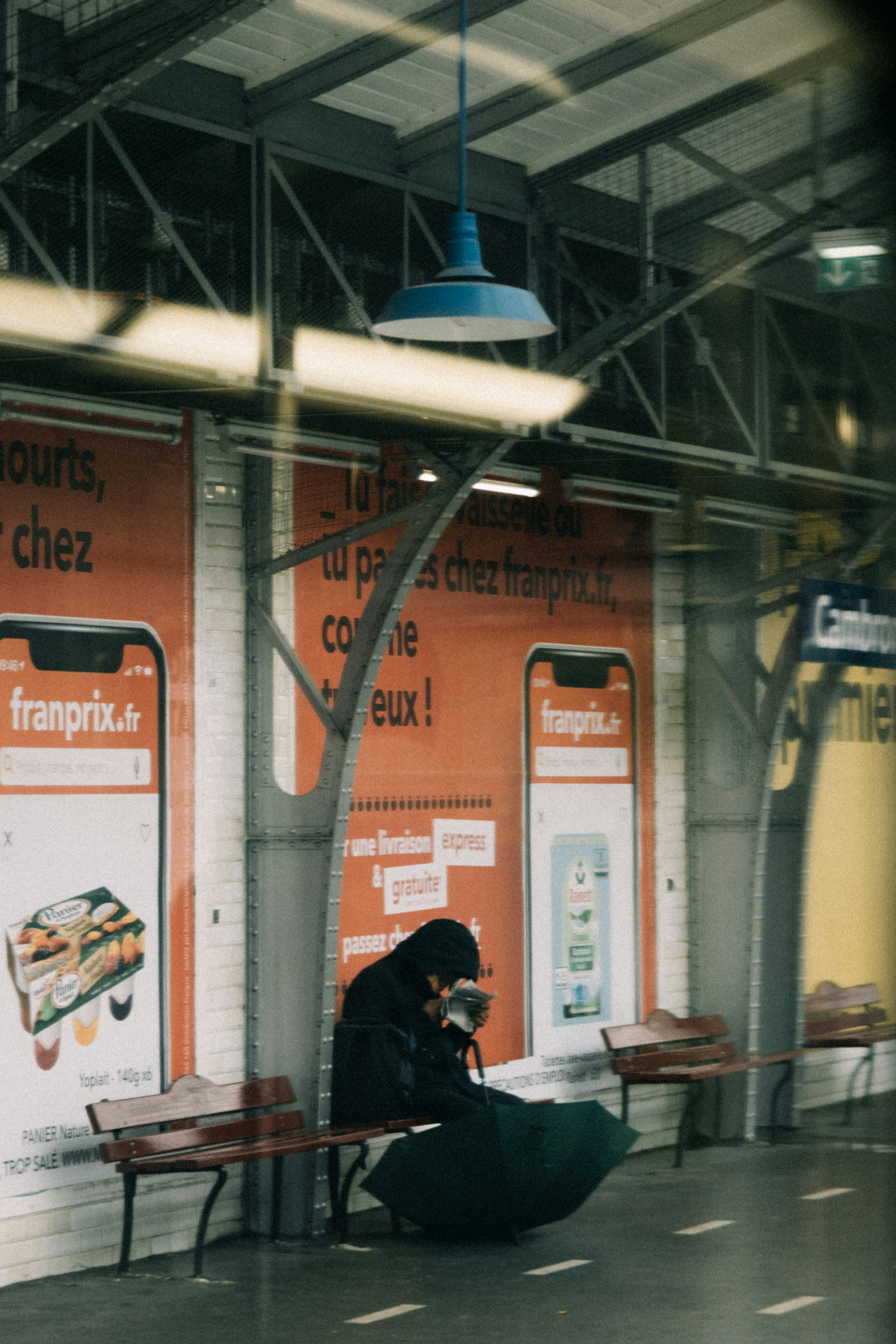 a woman sitting on a bench looking at her cell phone