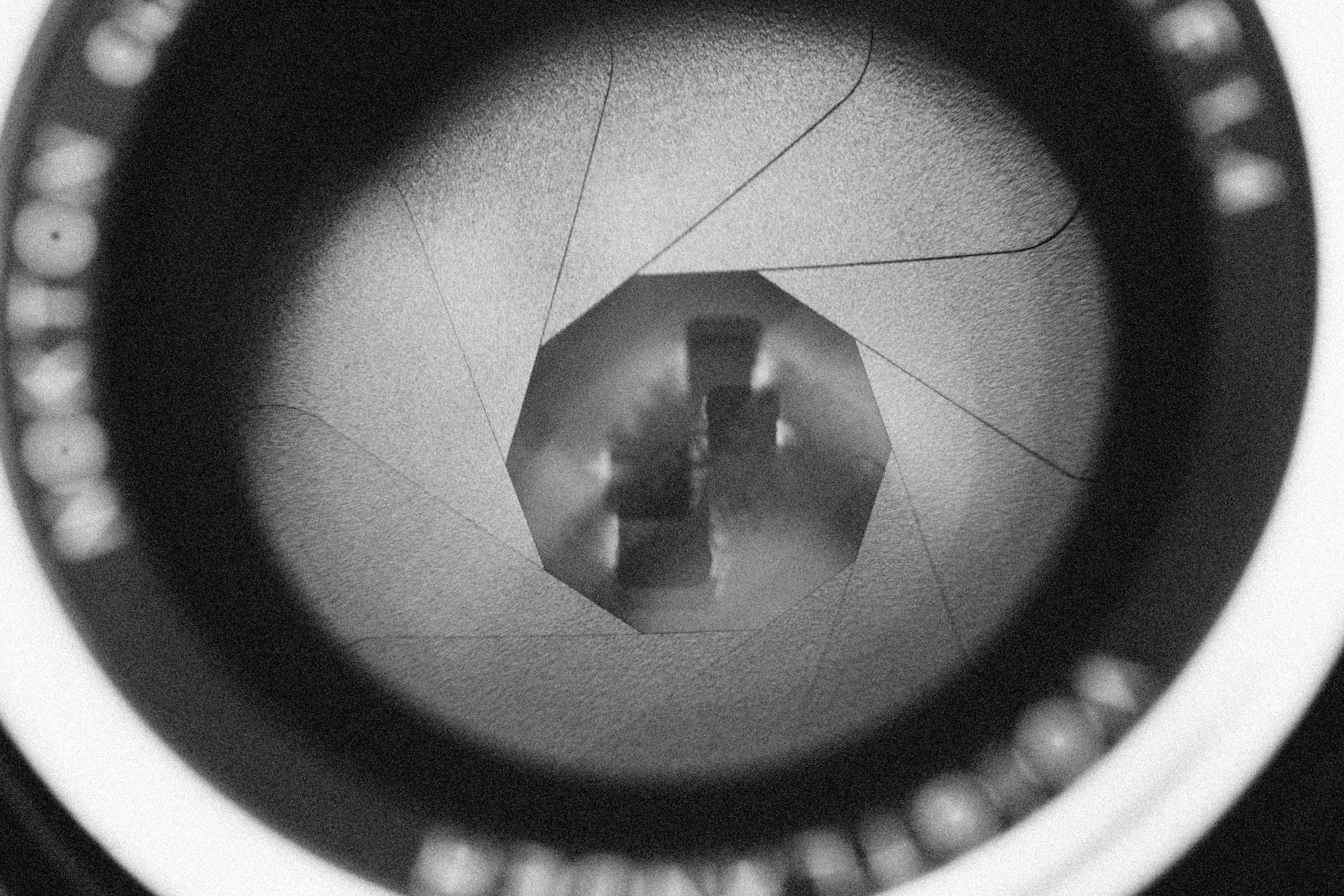 a black and white photo of a camera lens