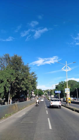 A bright, sunny day with a learner confidently merging onto a busy road.