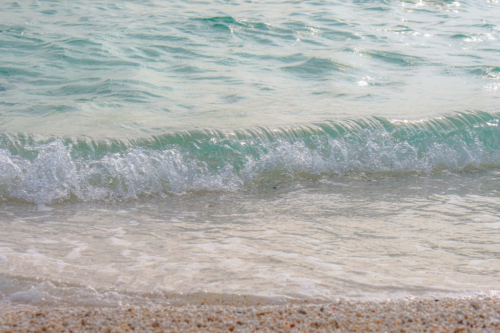 a beach with a wave coming in to the shore