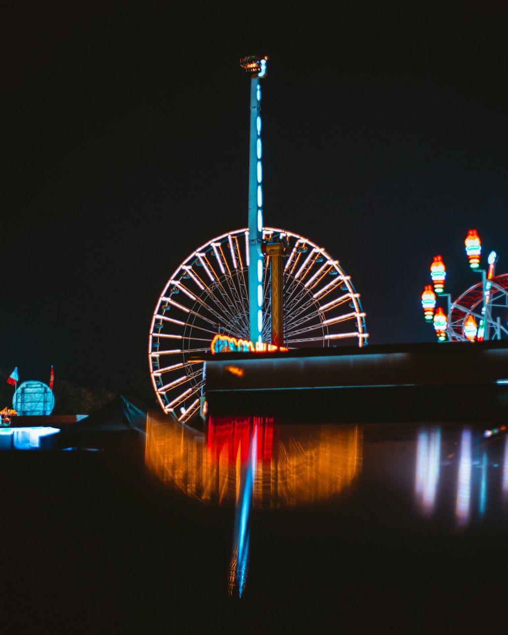 a ferris wheel lit up in the night sky