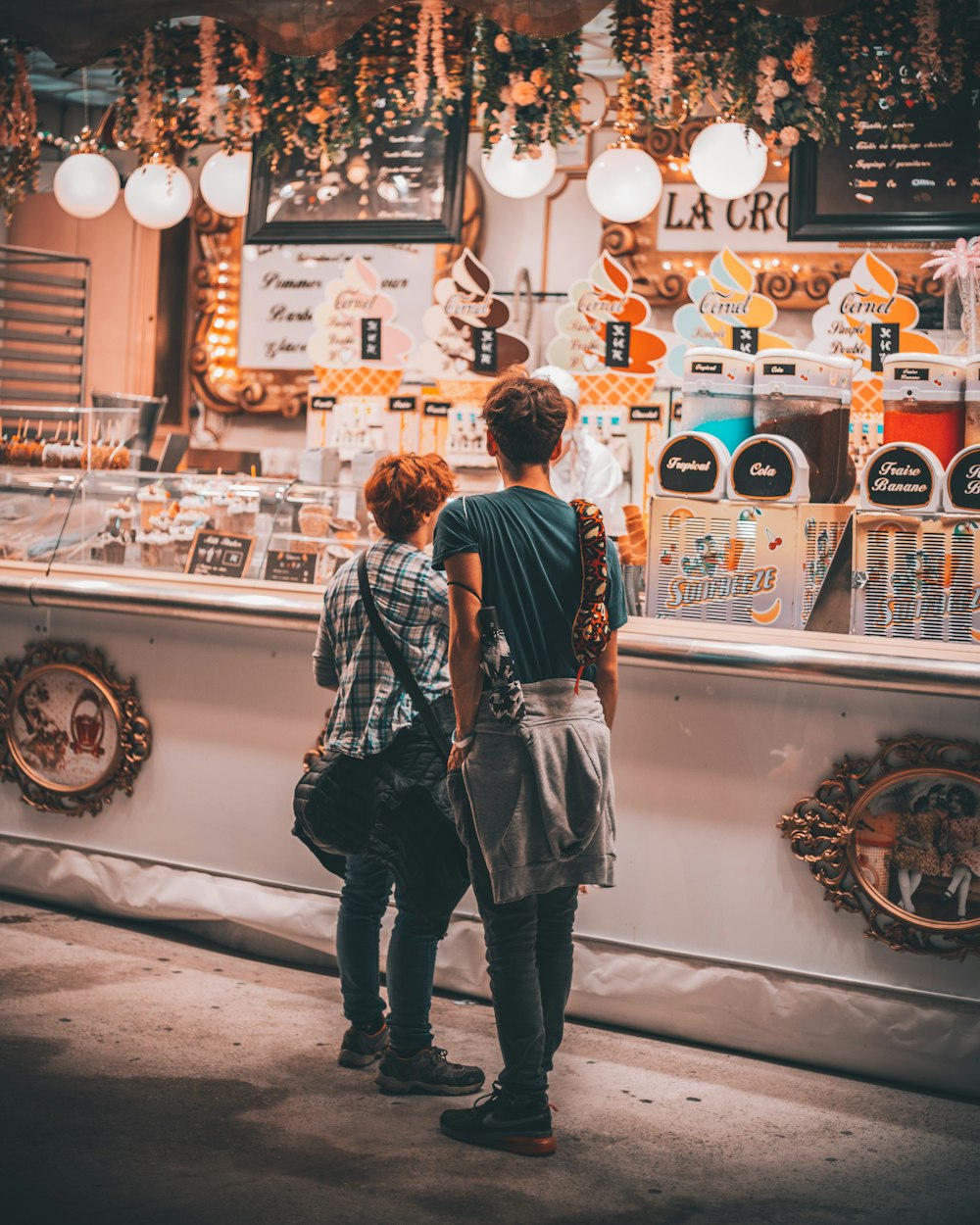 a couple of people standing in front of a store