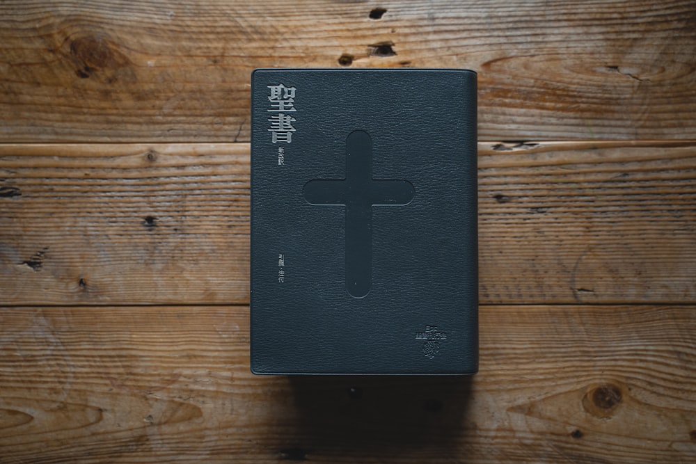 a black book with a cross on it