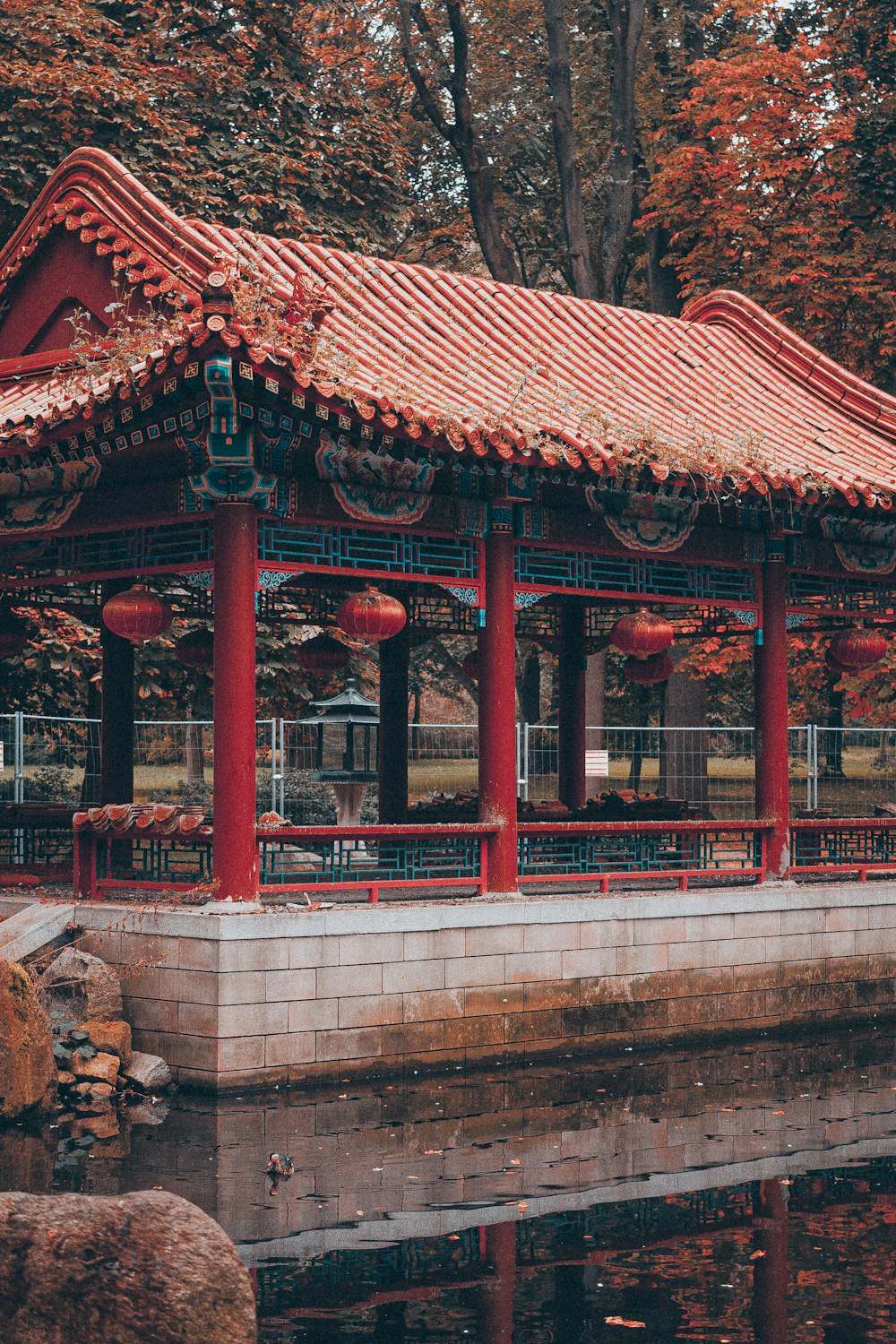 a red and blue building sitting next to a body of water